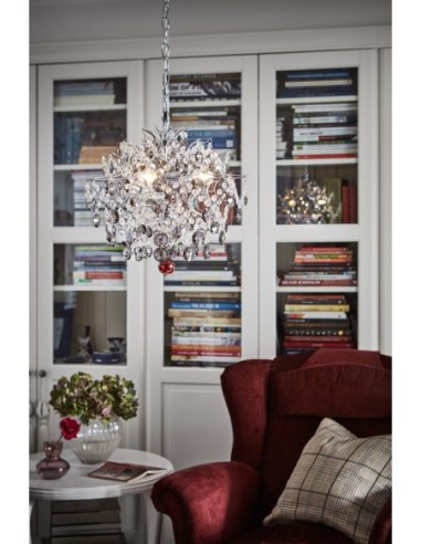 Structure en fer chromé et câble transparent, idéal pour un salon ou une salle à manger élégante.